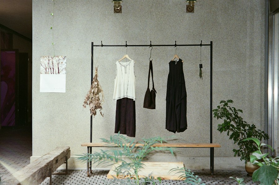 Minimal black and white clothing hanging in a studio